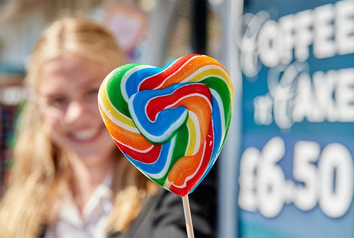  student holding lollypop  