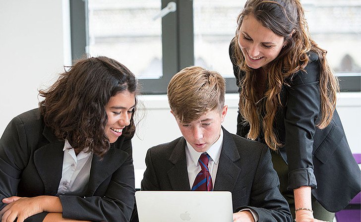  students collaborate around computer Hero  