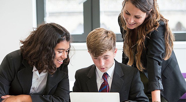  students collaborate around computer Hero  